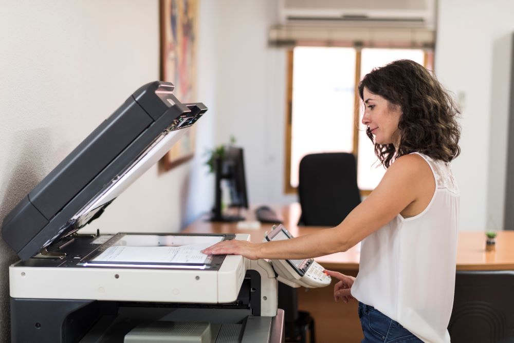 A woman operating office copiers