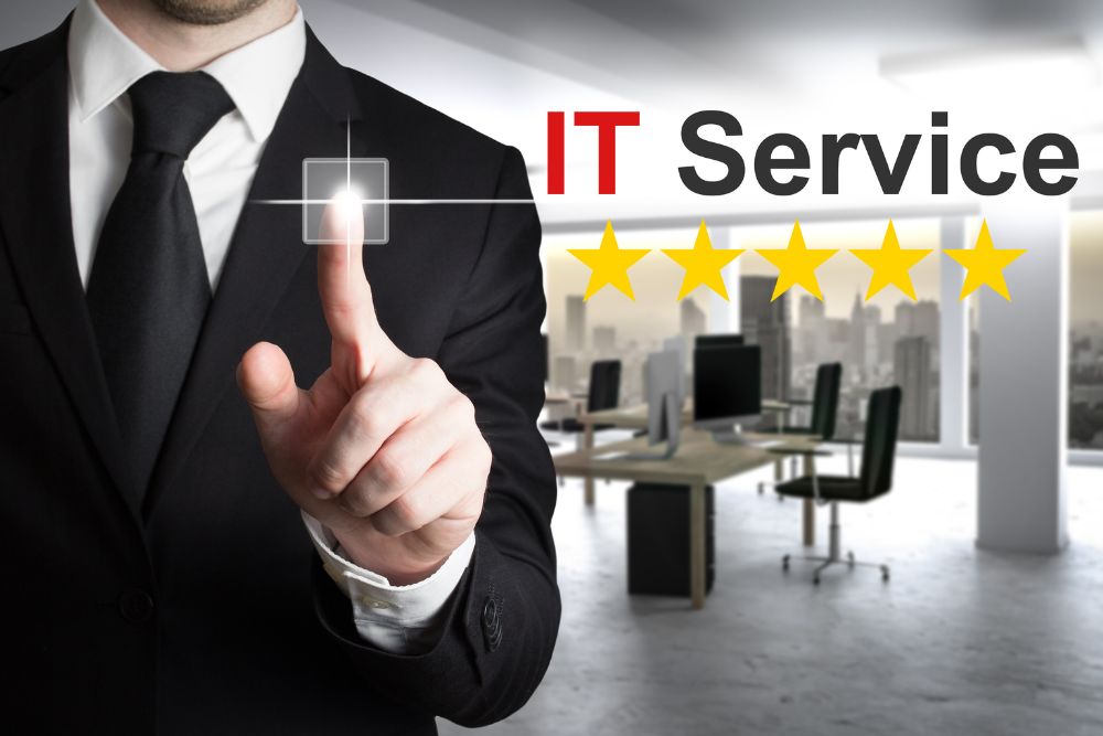 A business professional in a suit pointing to a virtual button with five stars and the text 'IT Service' in the background. This image represents high-quality IT Services, emphasizing professionalism and customer satisfaction.